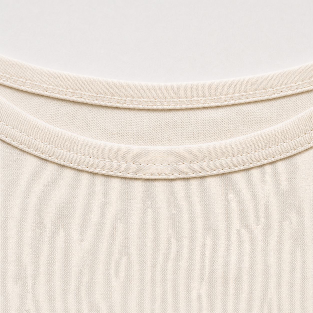 Self-fabric binding at the boat neckline, macro.