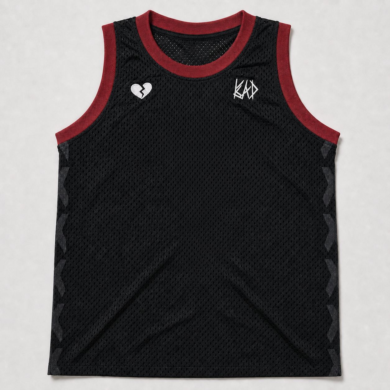 Jersey body before twill application, front — black mesh with maroon rib-knit trim, tonal DTF side X's, and embroidery at the chest.