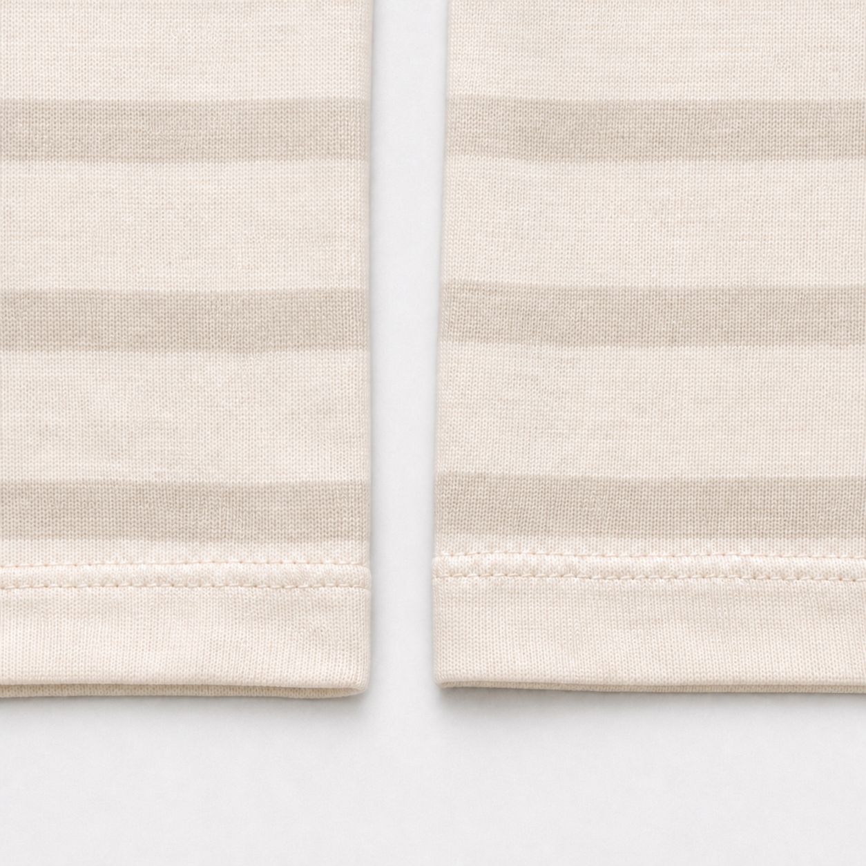 Plain self-fabric cuff turnbacks with double-needle stitching, macro.