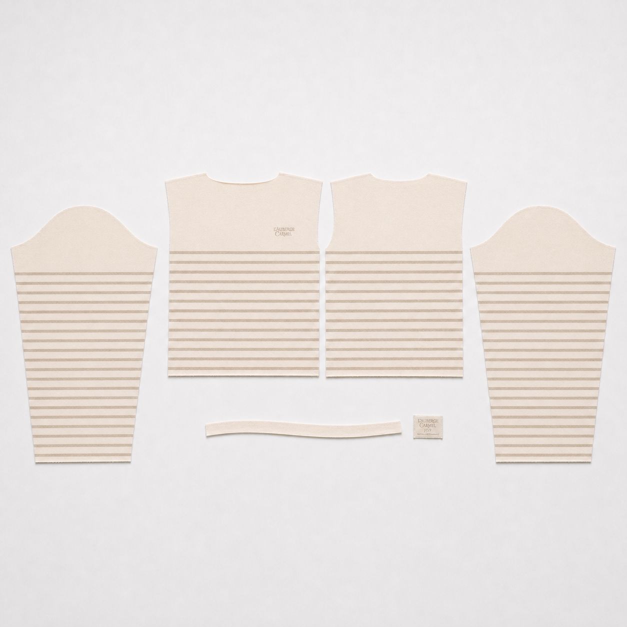 Pattern-cut front, back and sleeve panels with neck binding and woven label, before assembly.