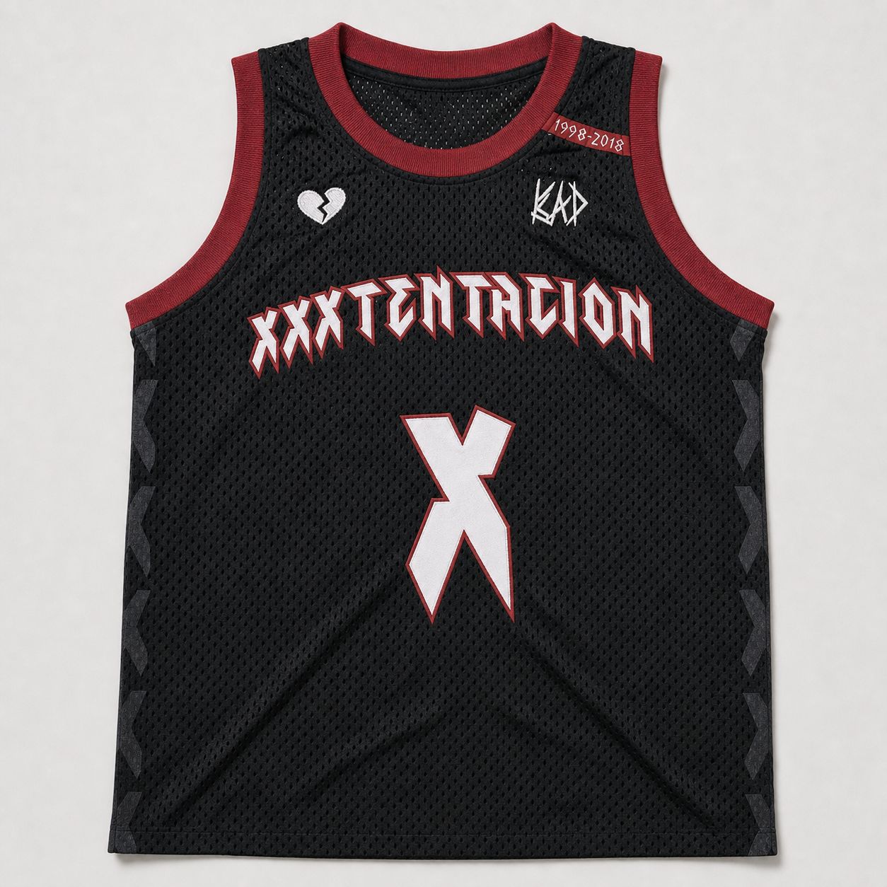 XXXTENTACION basketball jersey by Studio ATM, front — cut-and-sewn tackle twill wordmark and X on black athletic mesh.