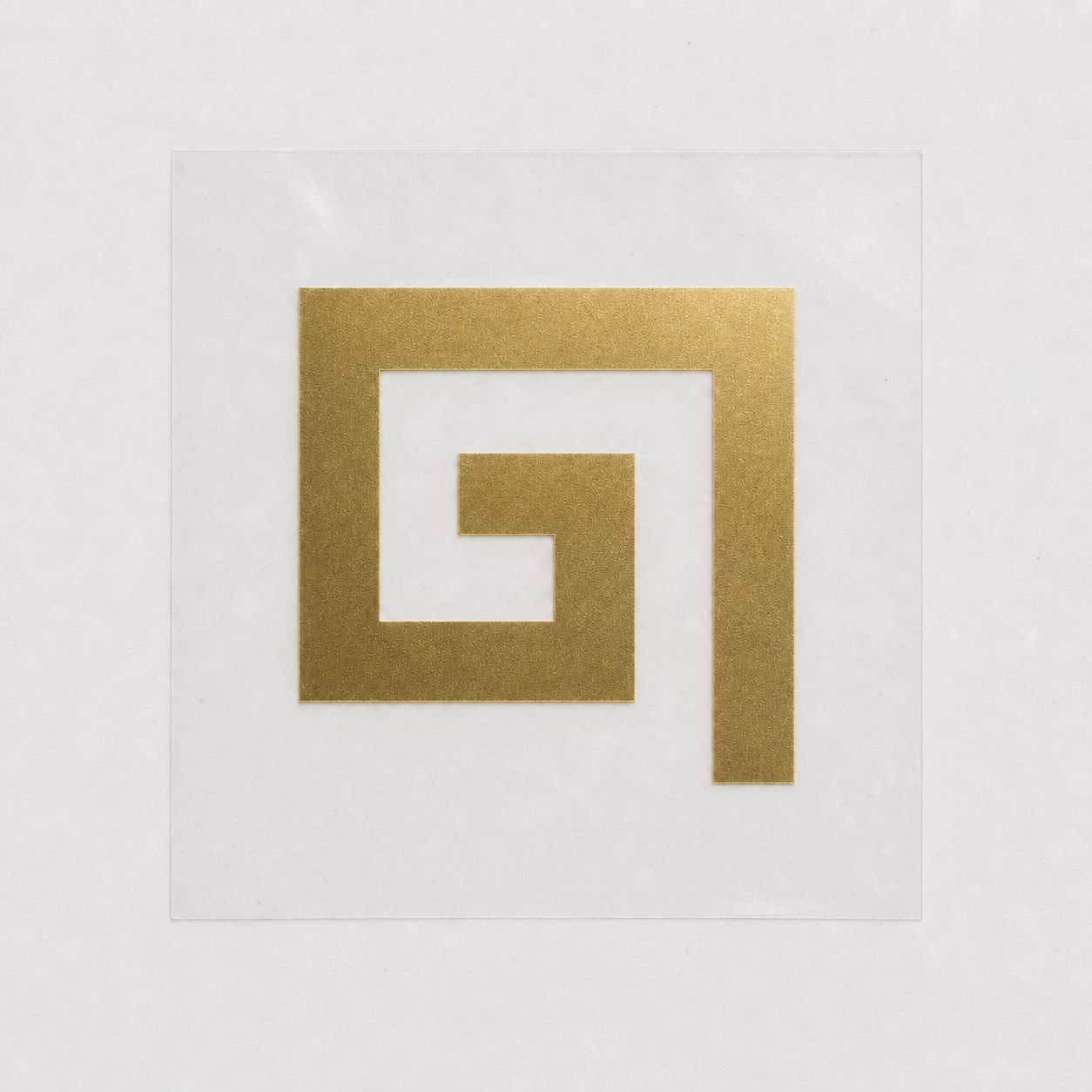 One repeat of the metallic gold Greek-key DTF vinyl transfer on carrier film.