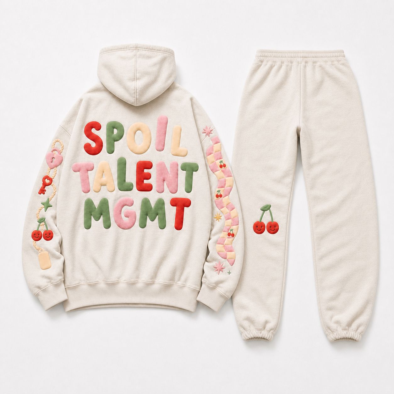 Spoil sweatsuit set back — SPOIL TALENT MGMT stacked in puff across the hoodie back, cherry pair on the pants.
