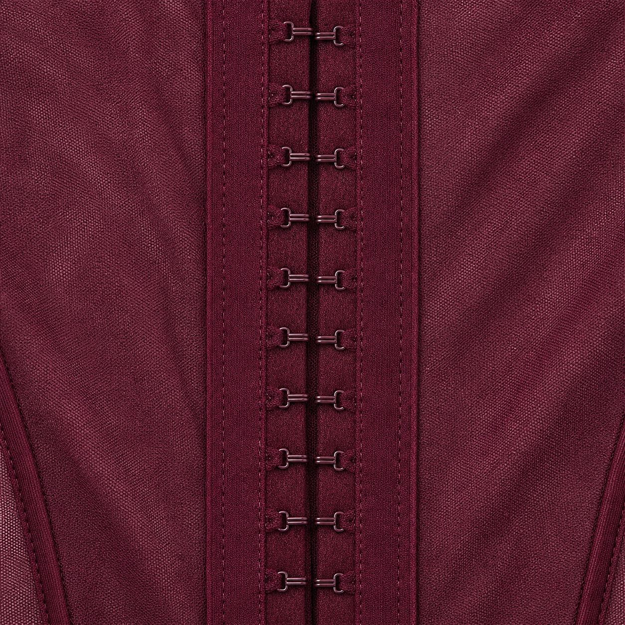Macro of the finished Dahlia gown center-back closure - tonal hook-and-eye hardware between sheer boned panels
