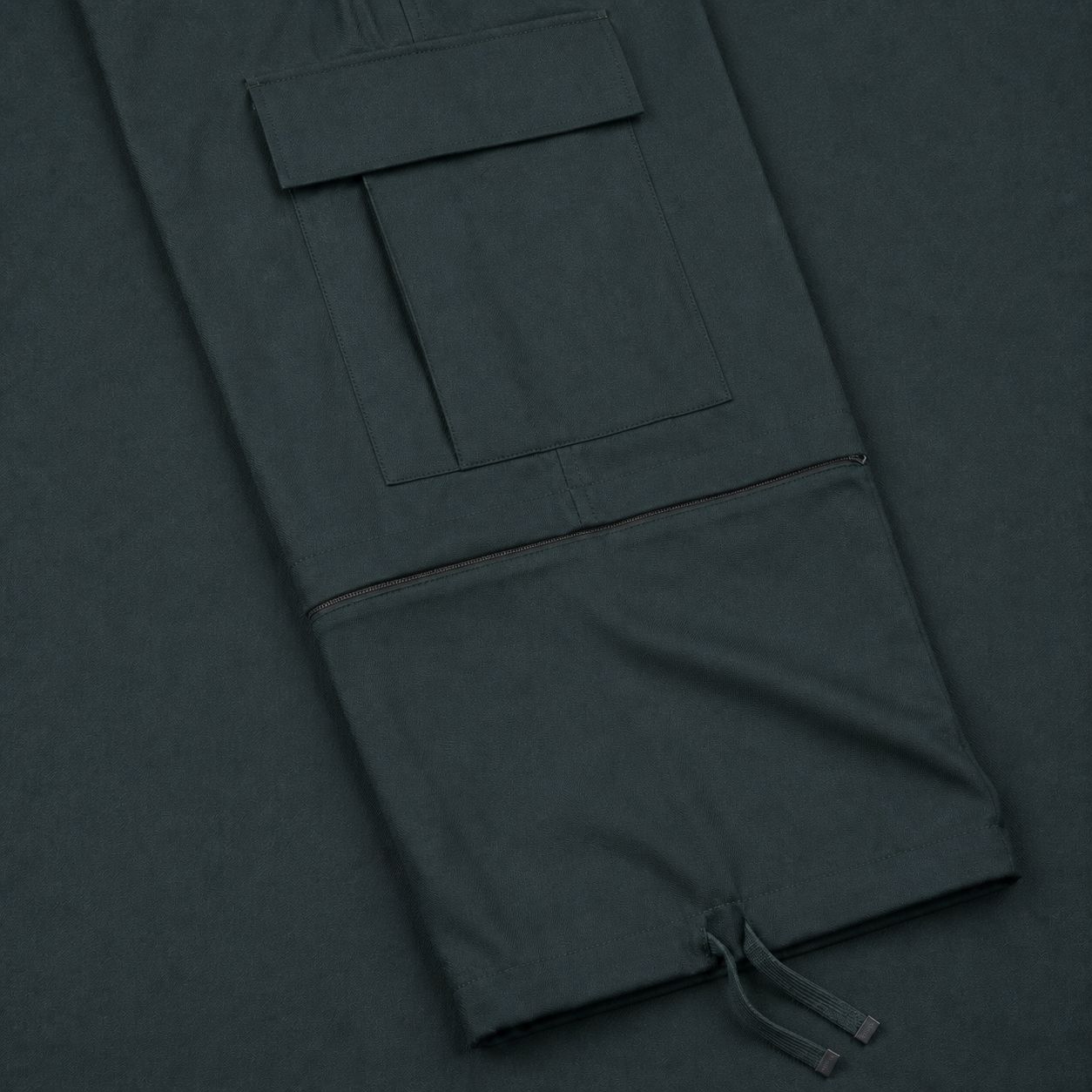 Macro of the flap cargo pocket, knee conversion zip and drawcord hem of the Zip-Off Cargo Pants