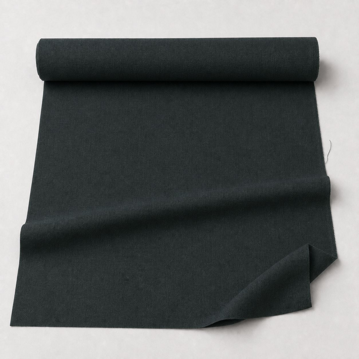Dark Forest fabric yardage for the vowels Zip-Off Cargo Pants - a bolt unrolled on the studio ground
