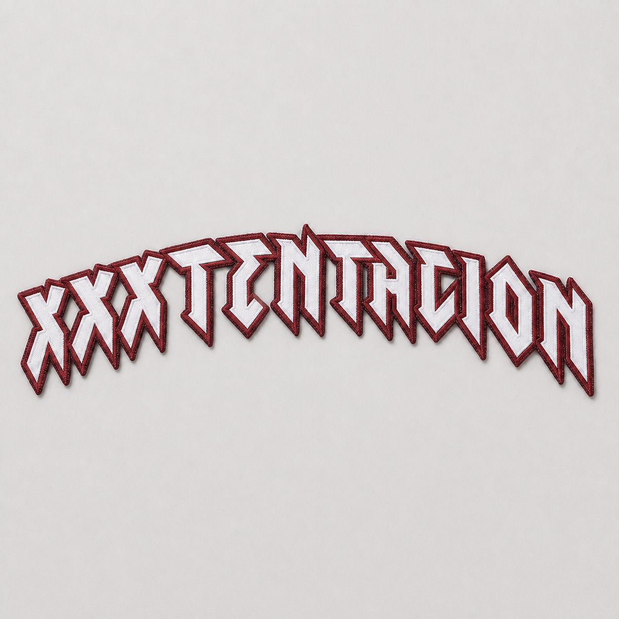 Cut-and-sewn tackle twill chest wordmark, white on maroon, pre-application.
